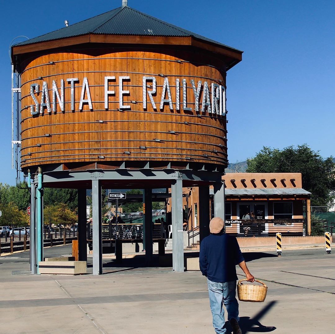 person walking in front of the water tower at the Railyard in santa fe photo by Instagram user @d_p_photo_