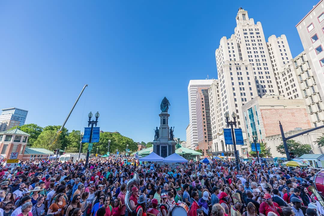 people outside at PVD Fest in Providence on bright blue sky day with buildings in background photo by Instagram user @matthewtwhuang