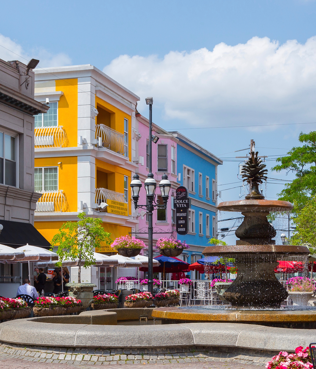 Federal Hill in Providence Little Italy with fountain and brightly painted buildings photo by Instagram user @federalhillri