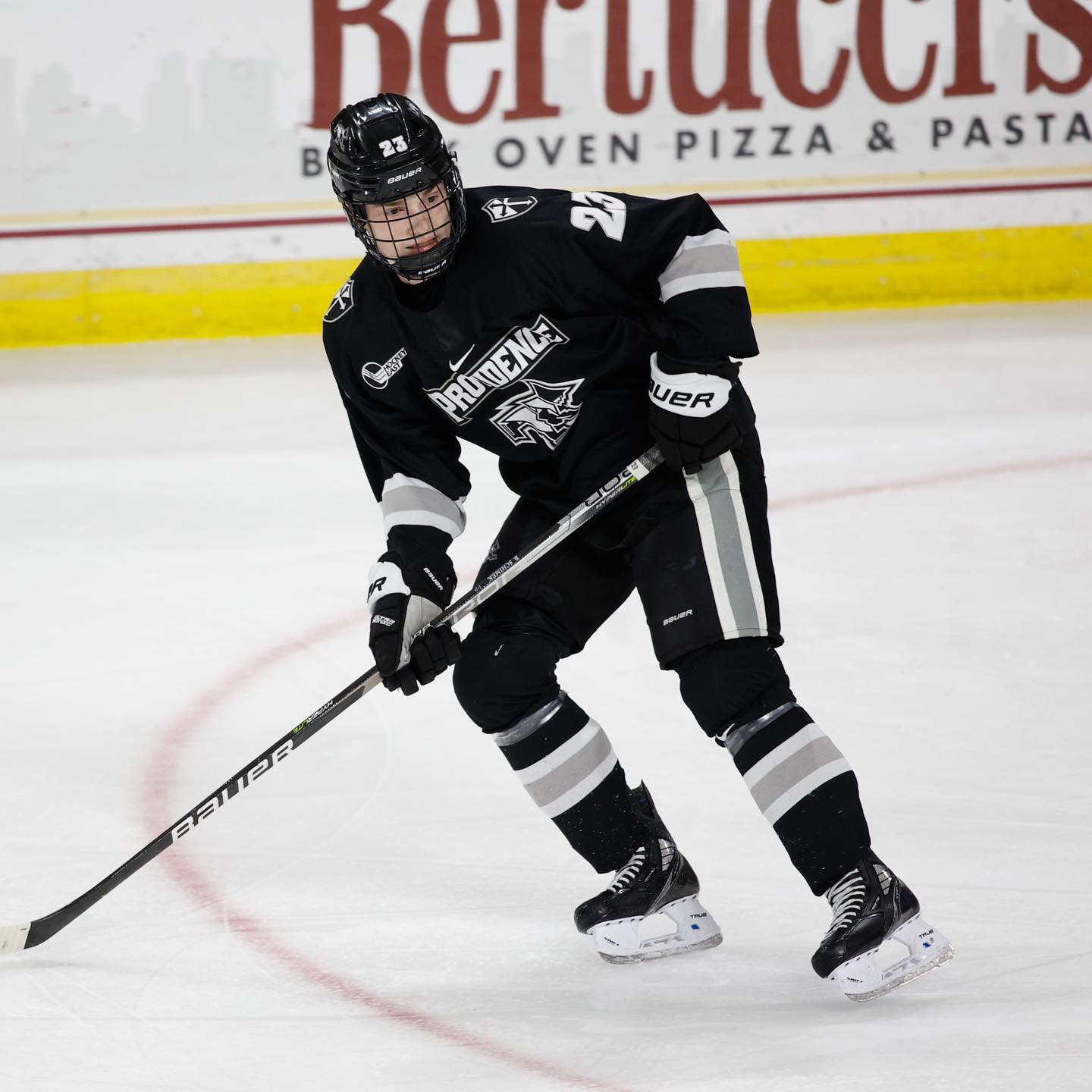 A hockey player on the Providence Friars hockey team skating during a match. Photo by Instagram user @friarshockey