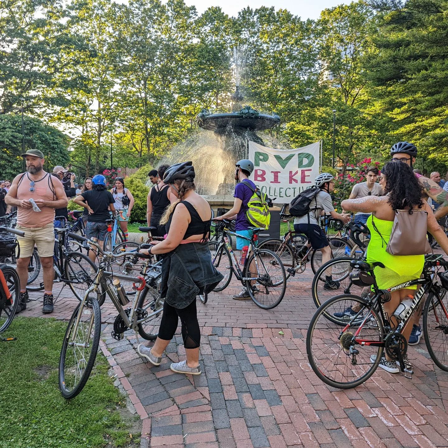 Riders getting ready for a ride with the PVD Bike Collective in a park. Photo by Instagram user @echasc
