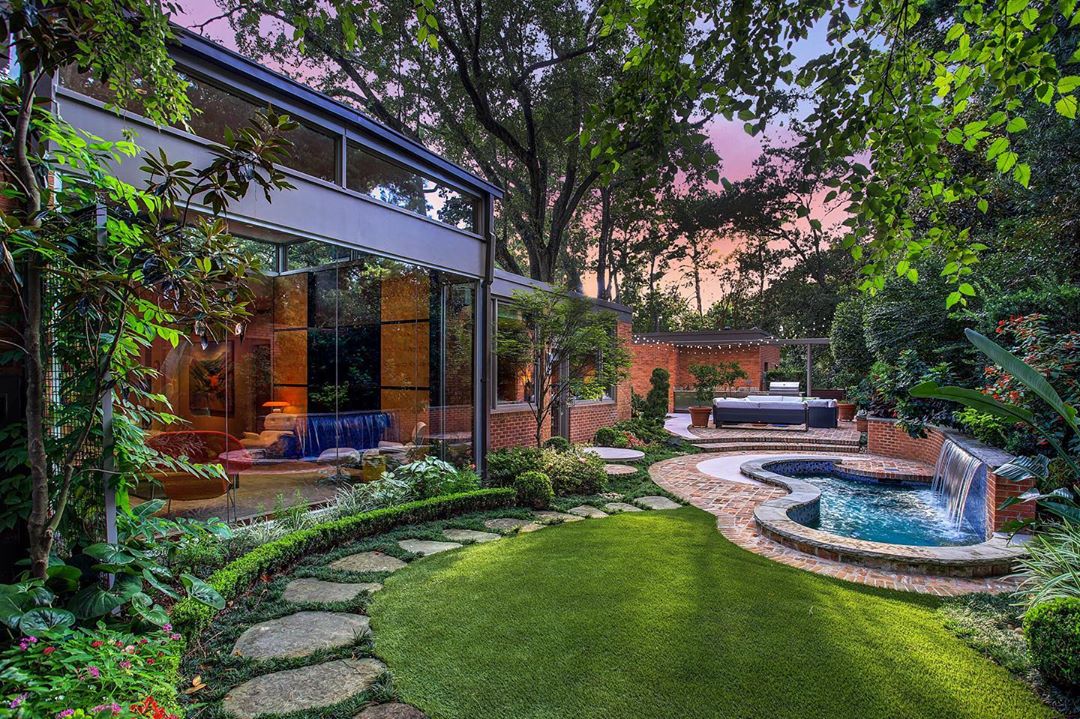 backyard space with a pool and open patio with trees all around photo by Instagram user @gailhartz_associates
