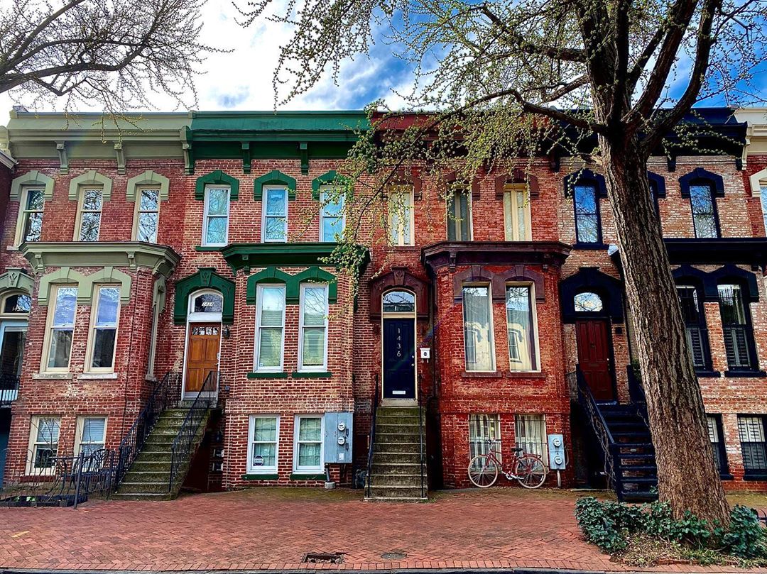 brick row houses with different color trim on each in Logan Circle, Washington, DC photo by Instagram user @sportyjordy15