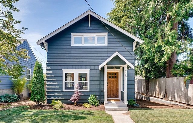 blue craftsman style home with white accents in Ballard, Seattle, WA photo by Instagram user @lakerealestate