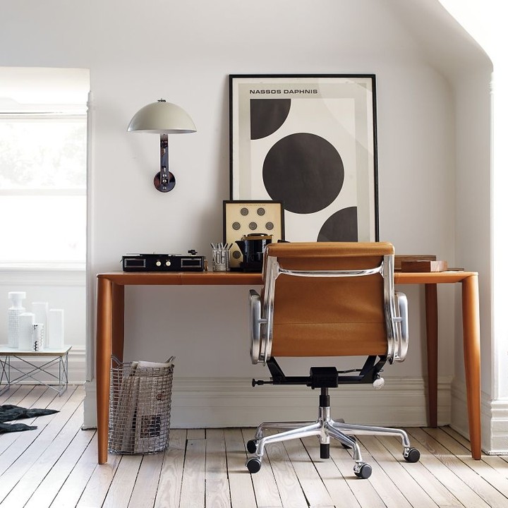 leather rolling desk chair at wooden desk photo by Instagram user @dwrtom