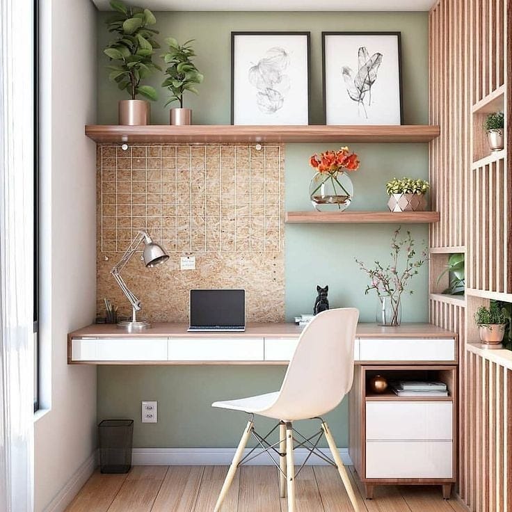 Home office with cork board backing and floating desk photo by Instagram user @raising.architecture