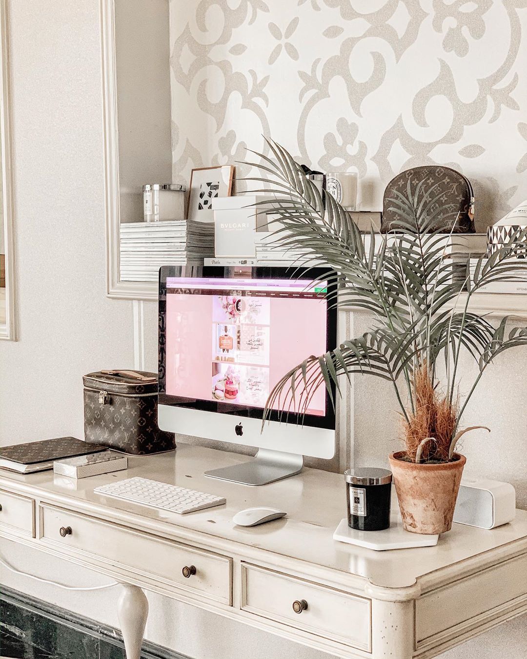 small home desk with iMac and small plant on desktop photo by Instagram user @fatmahilal7