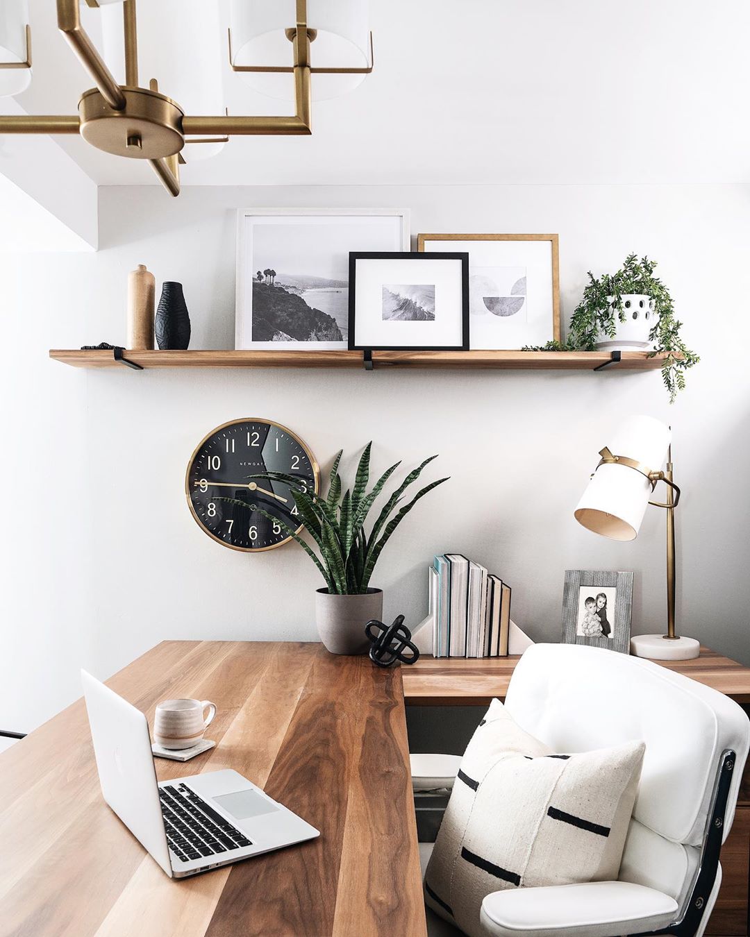 home office space with wodden desk and clock on the wall photo by Instagram user @leclairdecor
