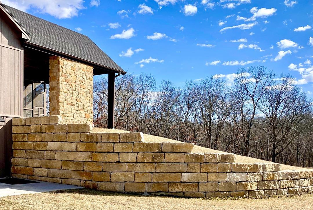 new retaining wall built alongside home in backyard photo by Instagram user @nativestonecompany