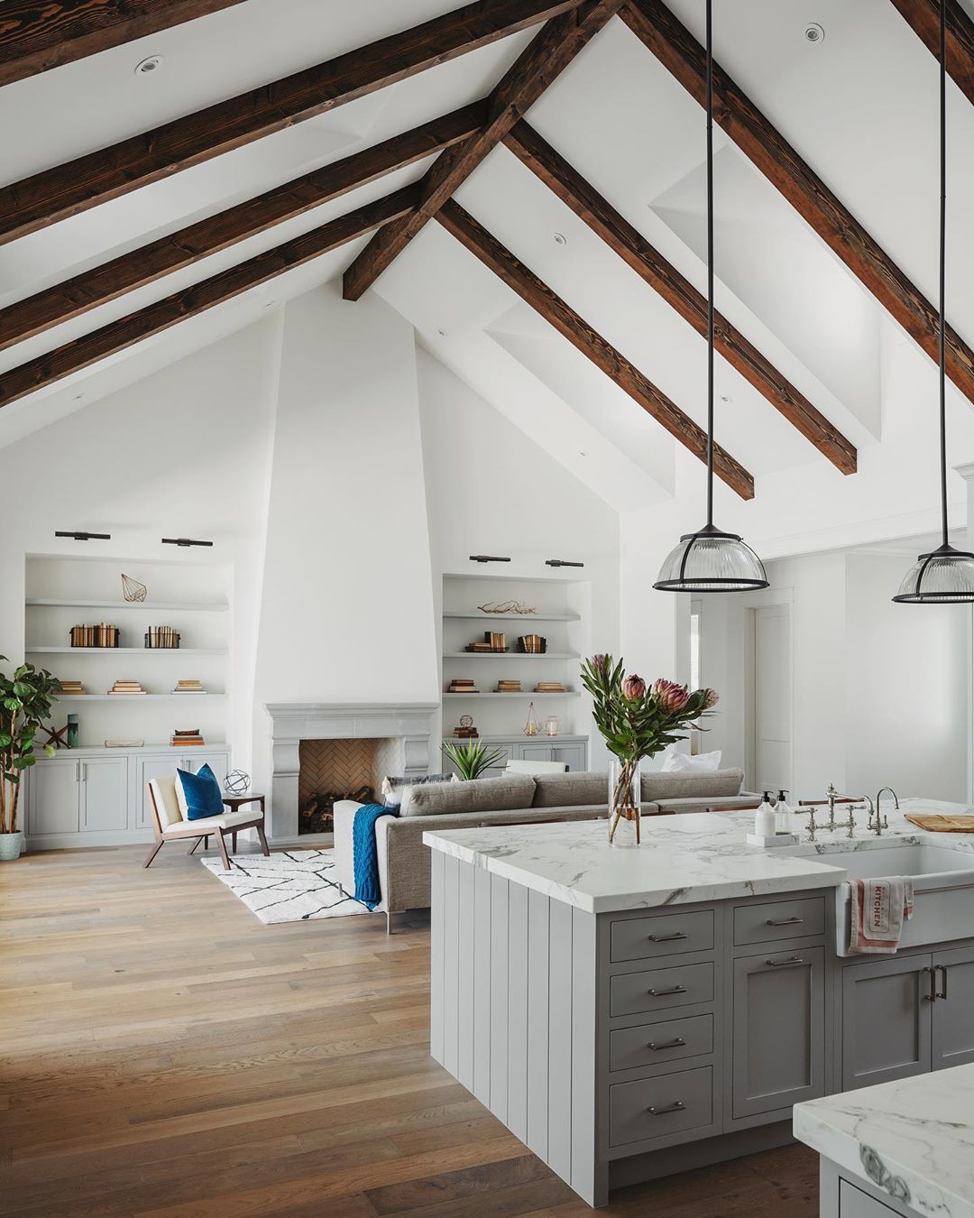 vaulted ceiling over living room and kitchen with wooden beams photo by Instagram user @roehnerryan
