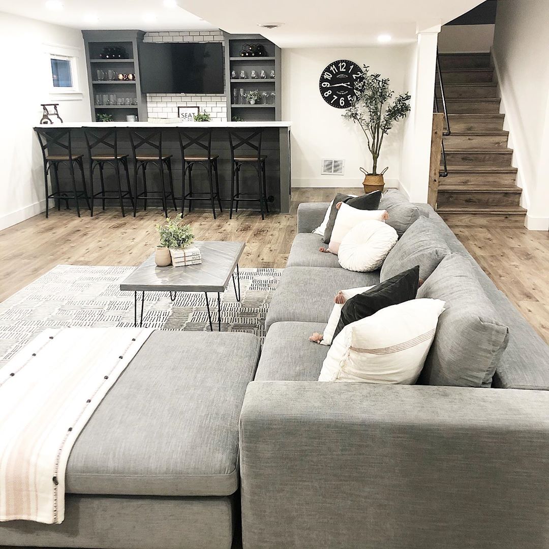 finished basement with full bar and large sectional photo by Instagram user @briemarie1023
