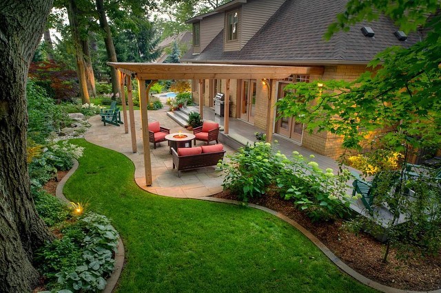 well landscaped backyard with outdoor living space and pergola photo by Instagram user @maritimewestconstruction