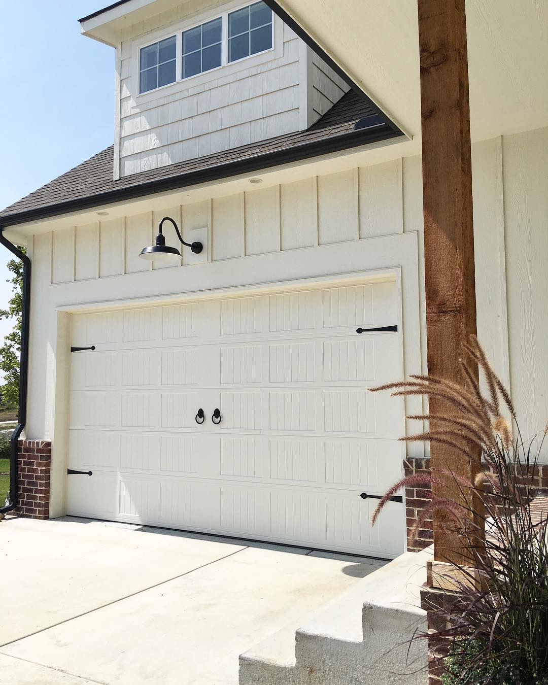 garage door with farmhouse style pieces added photo by Instagram user @concretecottage