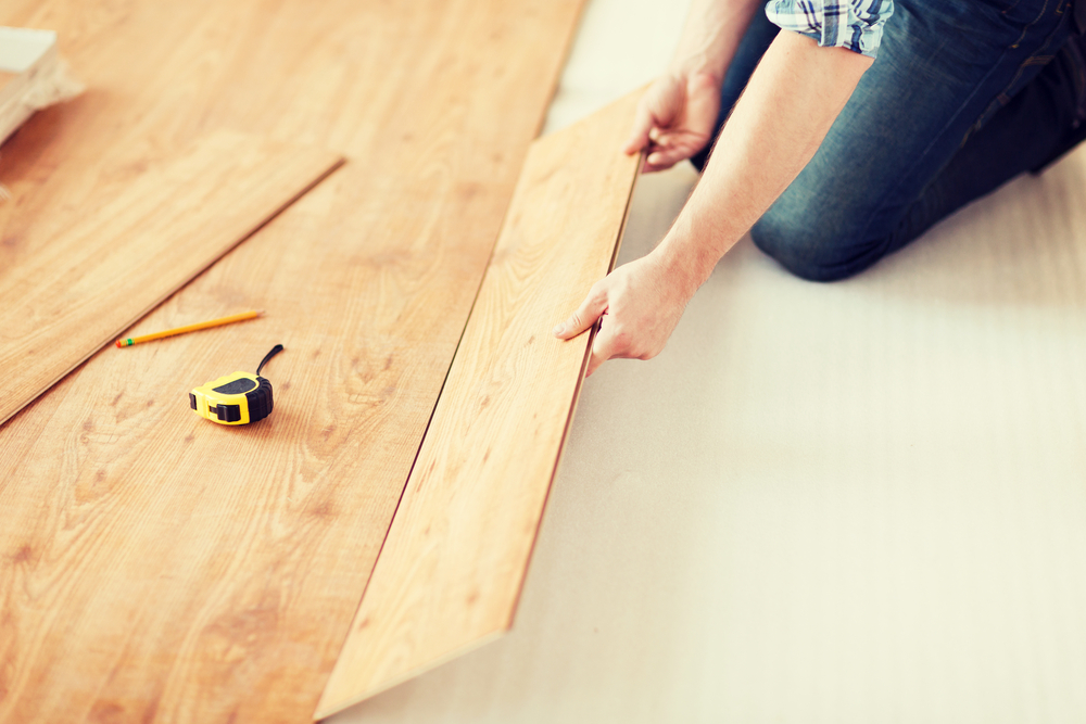 person installing wood flooring