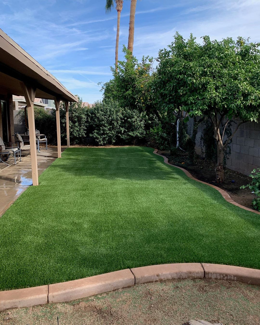 Artificial turf installed in small backyard.