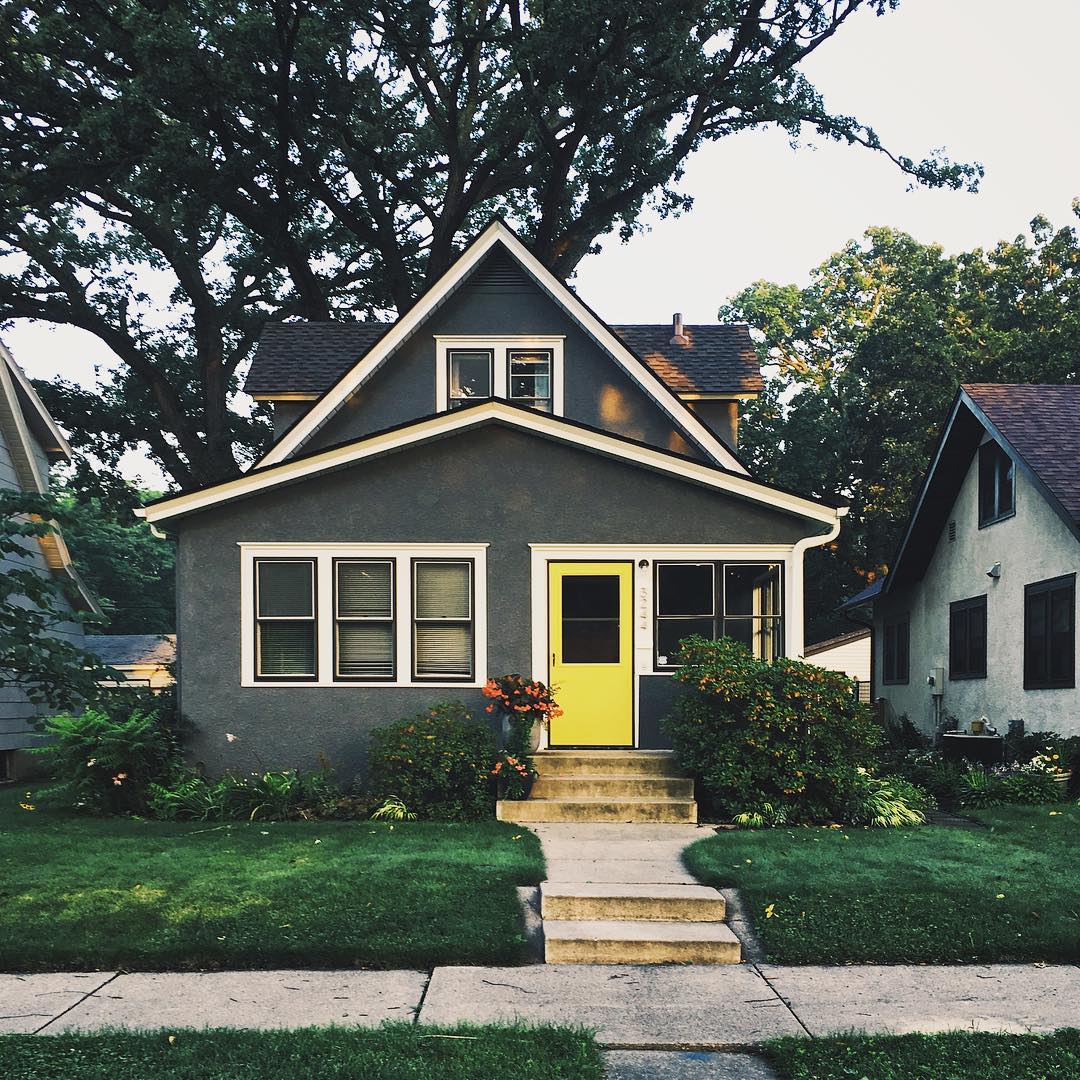 bungalow style home in minneapolis with yellow door photo by Instagram user @studiohahn