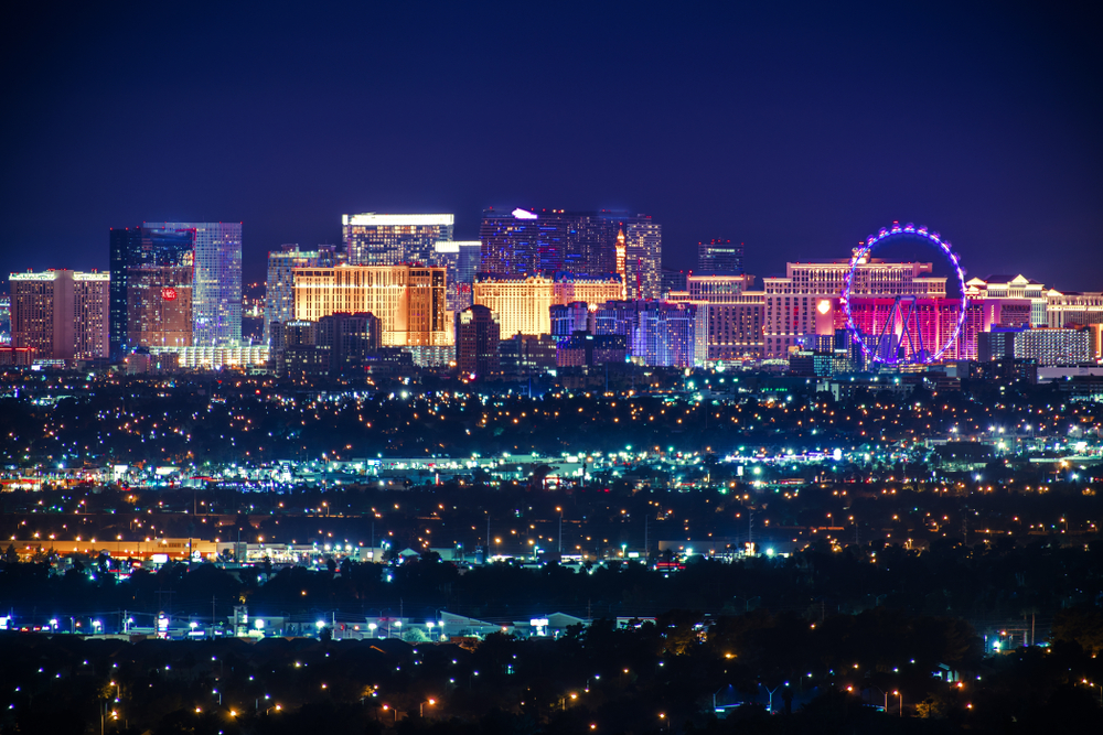 Las Vegas ferris wheel, casinos, and neighborhood streets lit up at night