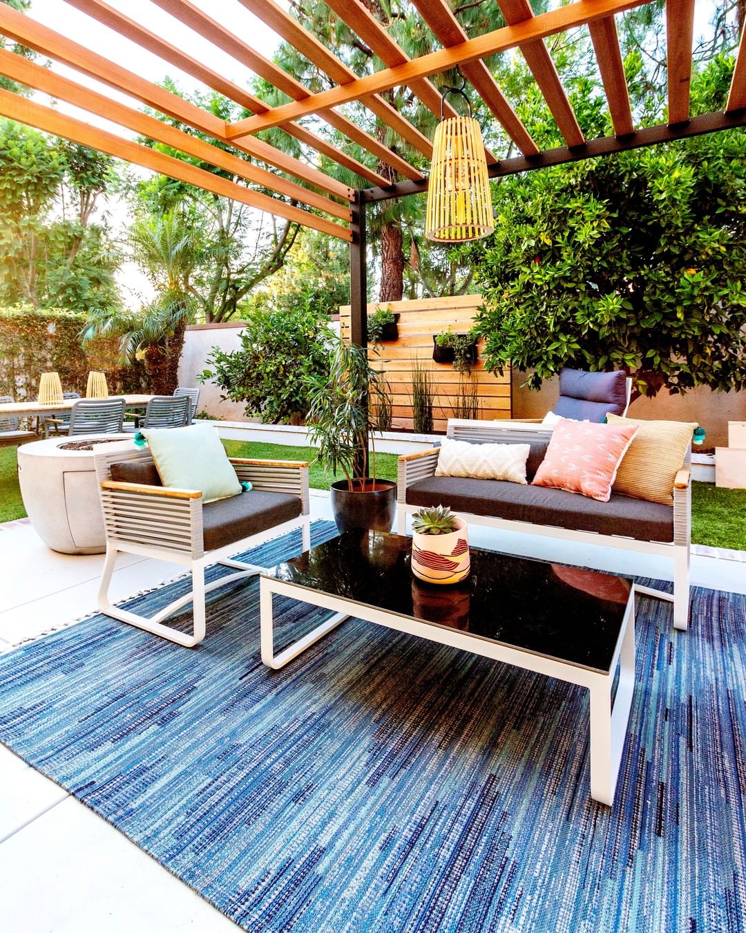 outdoor living space with pergola and outdoor rug photo by Instagram user @anitayokota