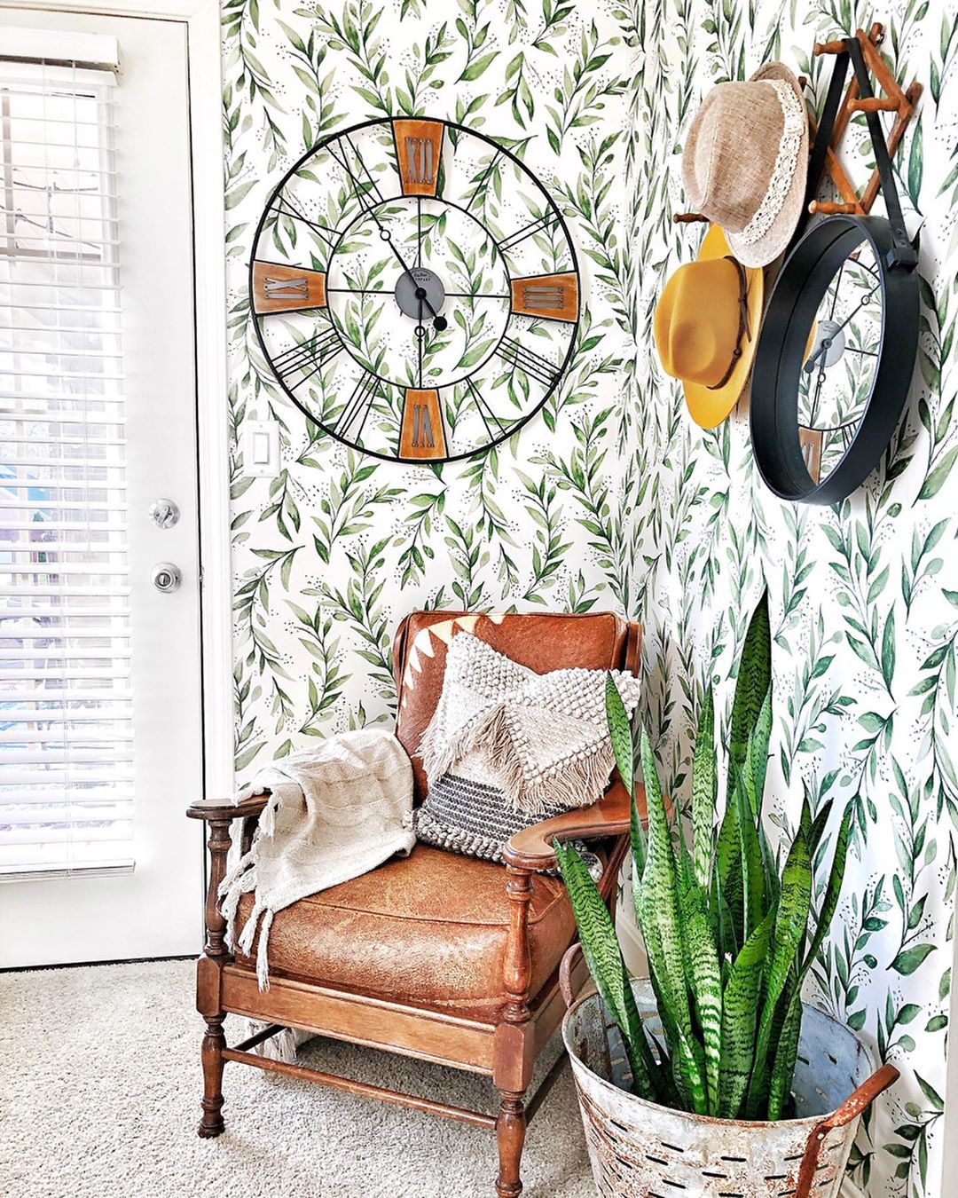 home with removeable wallpaper with olive branch pattern and leather chair in front photo by Instagram user @my_graceful_mess