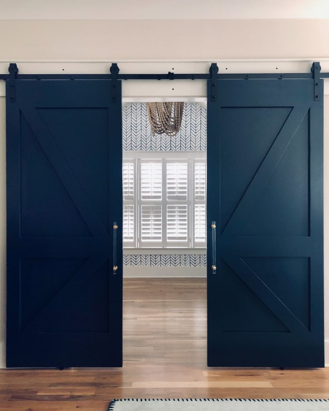 blue barn doors installed in a new home photo by Instagram user @fieldshandcrafted