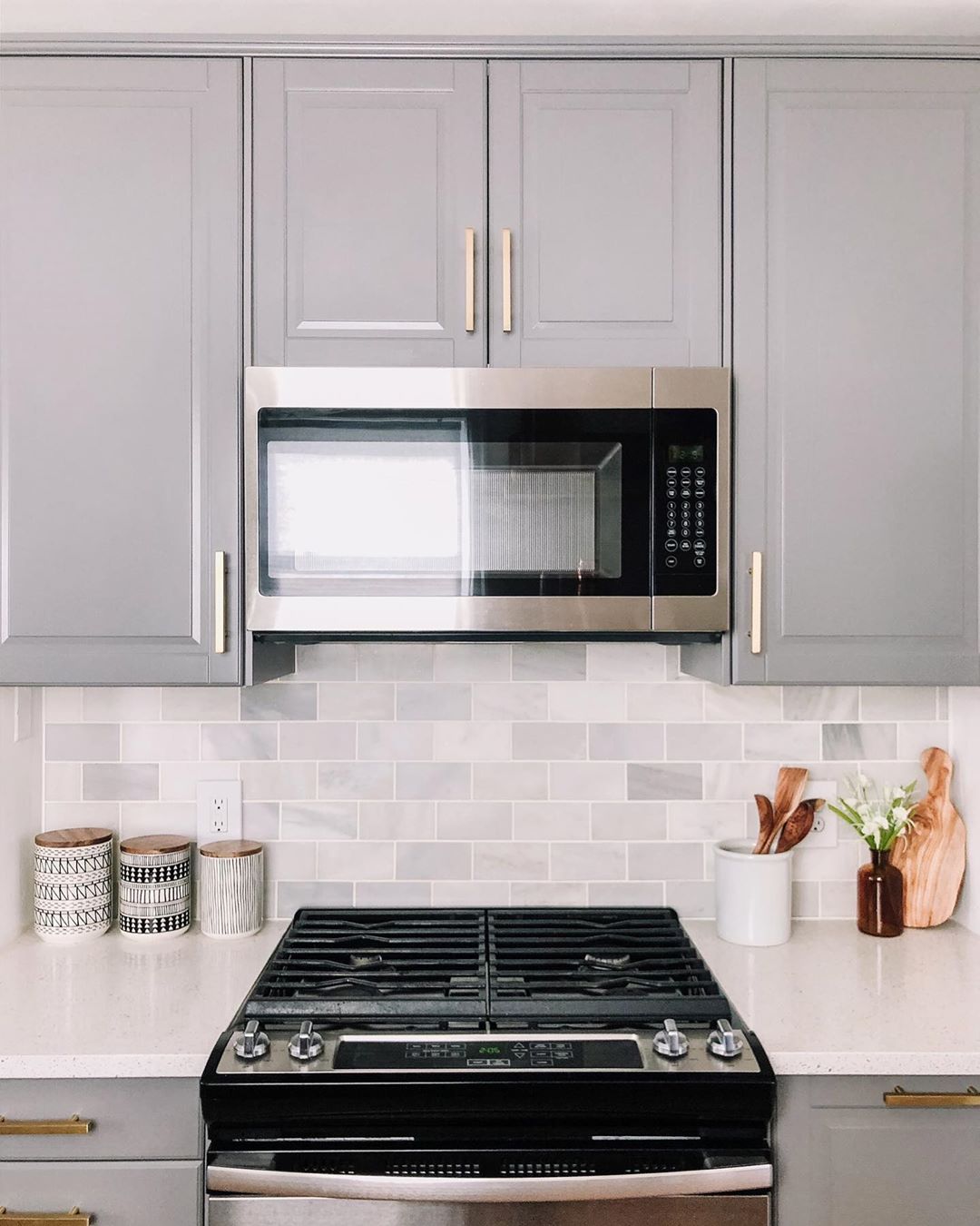 updated kitchen with tile backsplash and gray cabinets photo by Instagram user @beangardn