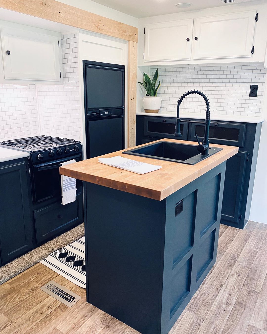 new RV kitchen island with farmhouse faucet and butcher block counter photo by Instagram user @tiny.living.erin