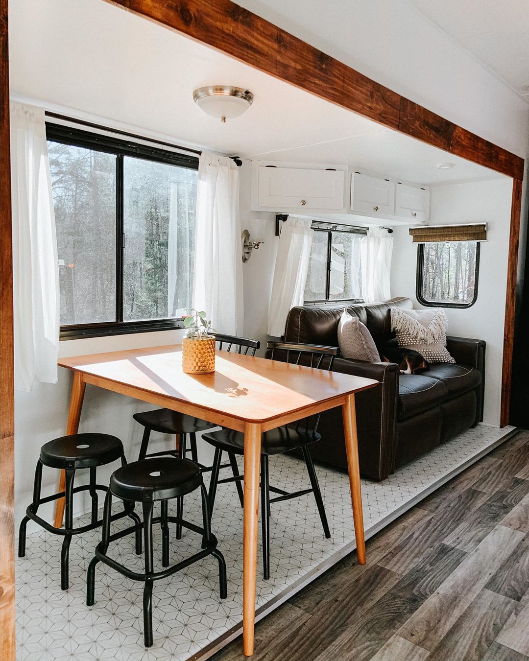 updated windows in new RV with dining table photo by Instagram user @choosing.less