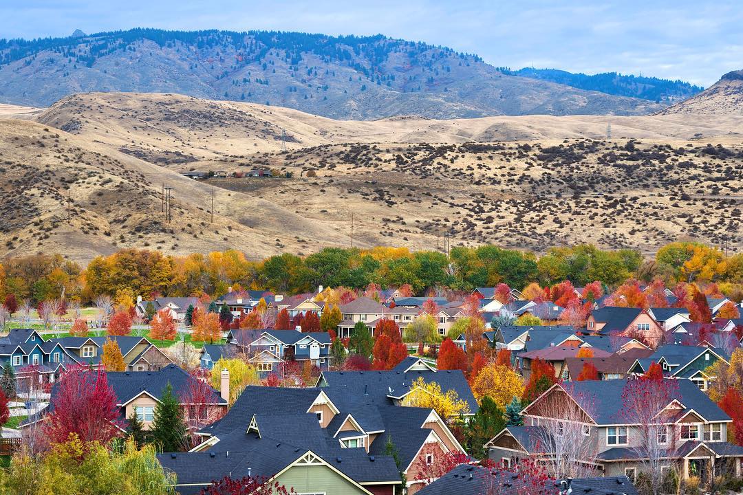 view of the hills in Boise behind the homes photo by Instagram user @relocationboiseidaho