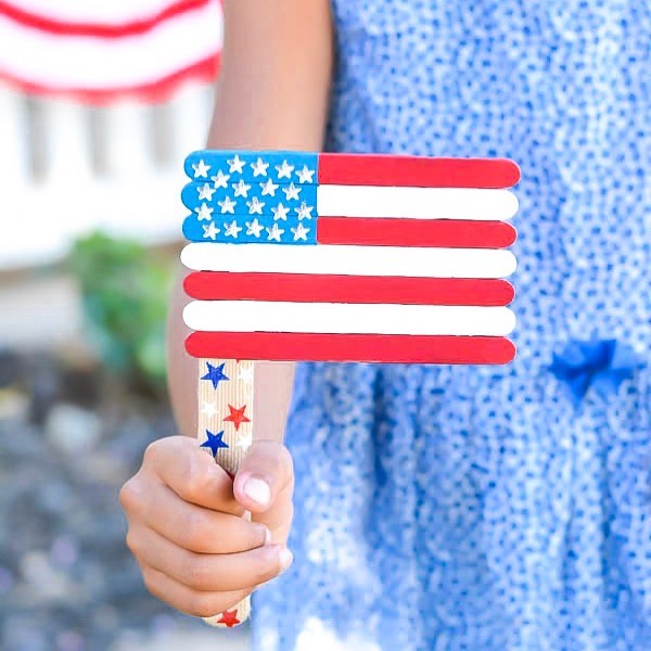 Child Holding American Flag Made of Popsicle Sticks. Photo by Instagram user @apumpkinandaprincess