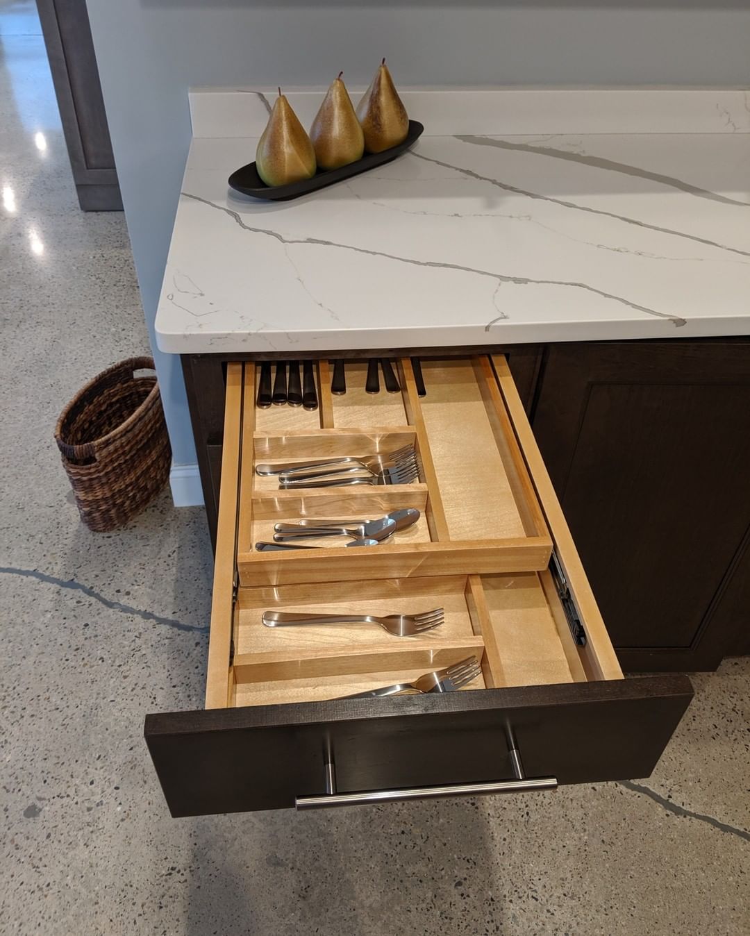 Kitchen drawer with double sliding drawer for utensils. Photo by Instagram user @benchmarkkitchenandbath