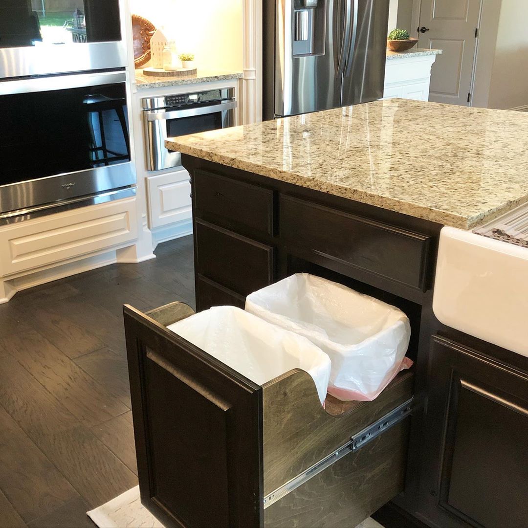 Garbage cans added into sliding drawer in kitchen island. Photo by Instagram user @hammonshaven