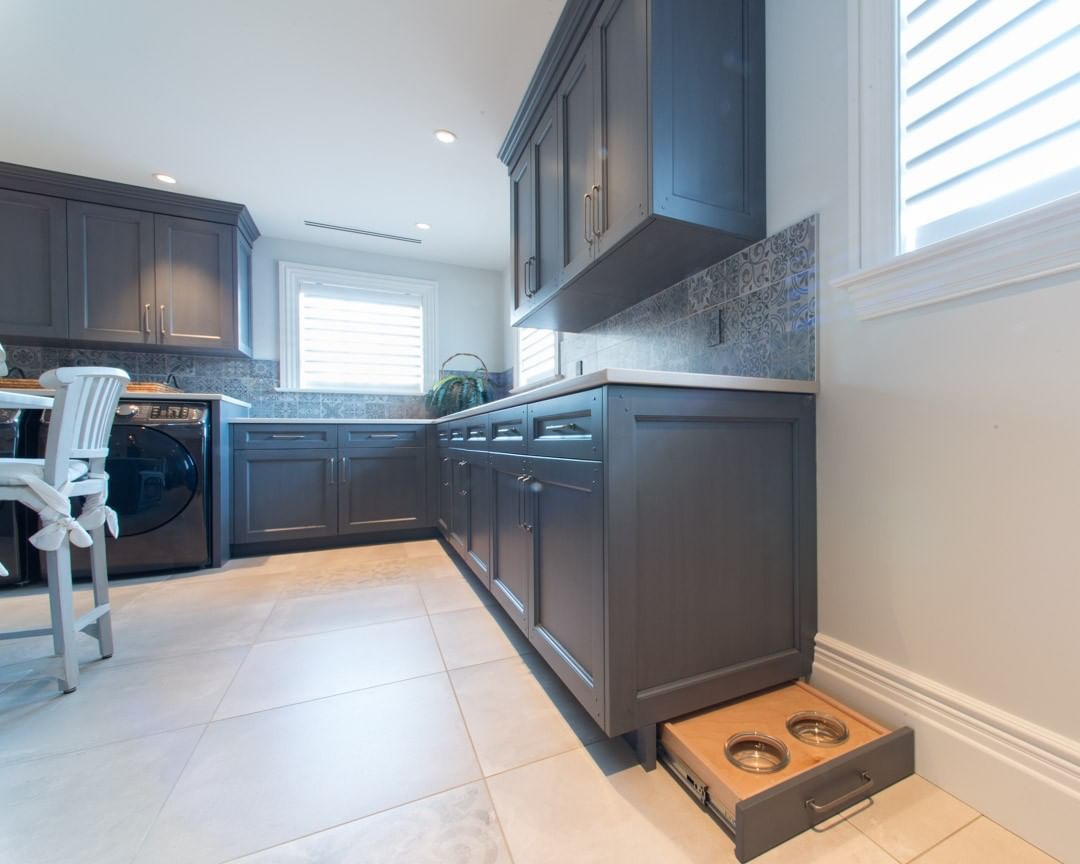 Pet bowls added into laundry room toe kick drawers. Photo by Instagram user @oberholtzer_cabinetry