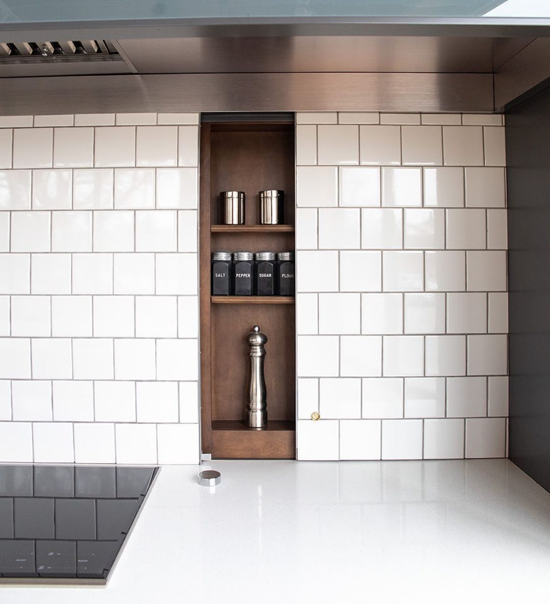 Hidden spice cabinet behind backsplash. Photo by Instagram user @theredlobby