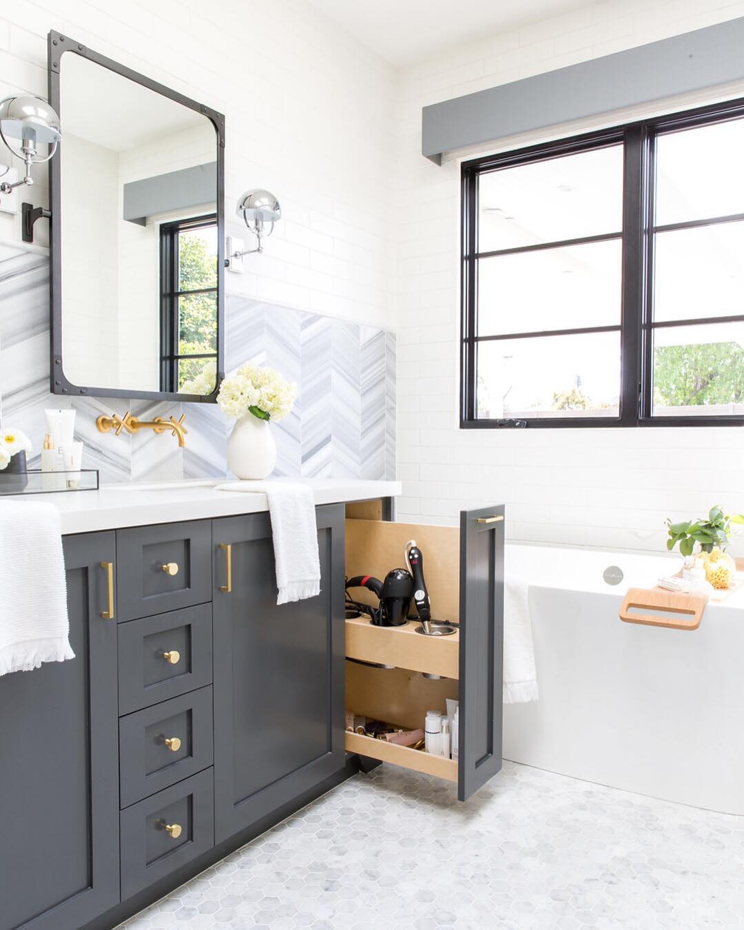 Hidden storage spot for hot hair tools in bathroom. Photo by Instagram user @ lindyegalloway