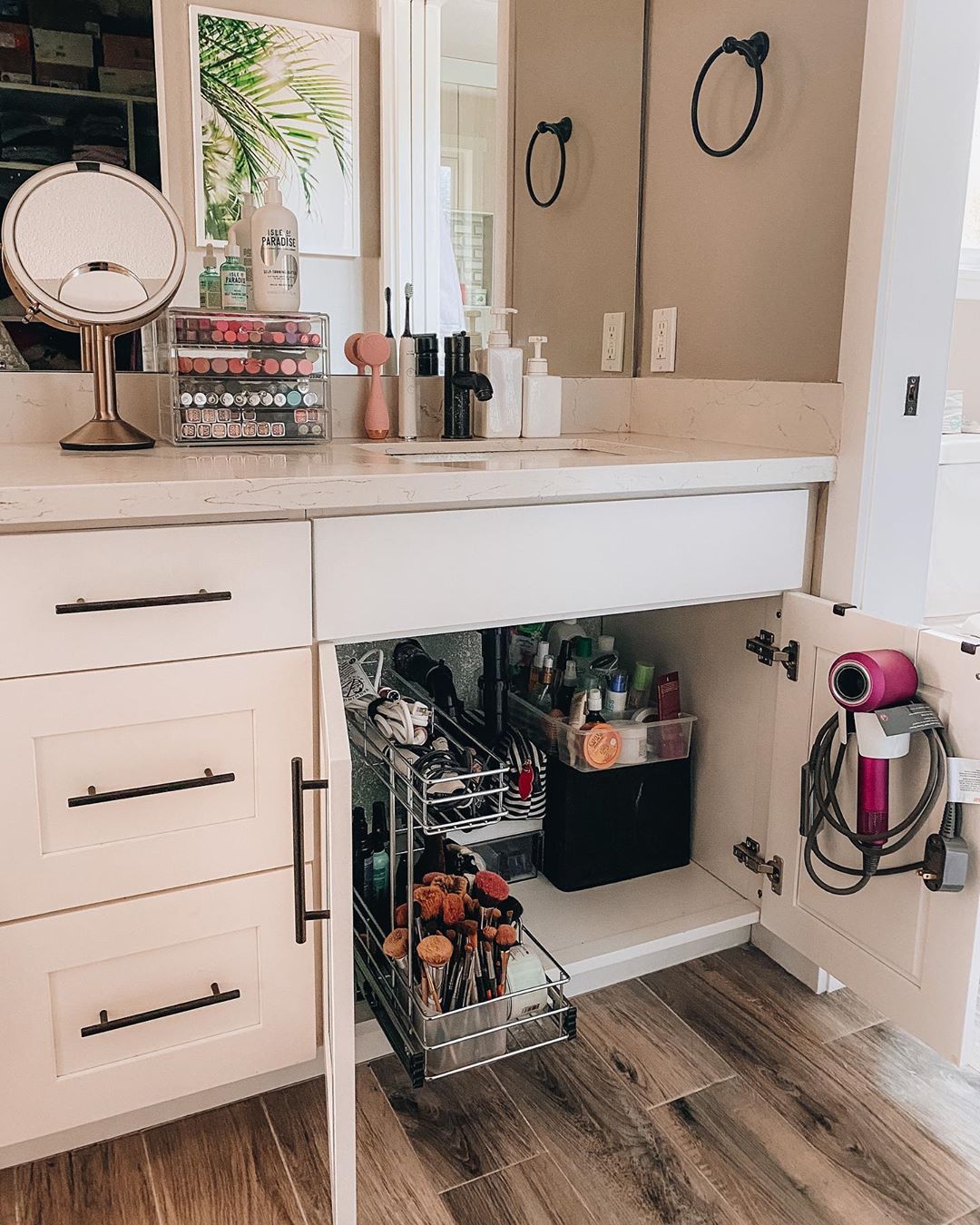 Storage added to the back of vanity cabinet doors in the bathroom. Photo by Instagram user @tiffanyish