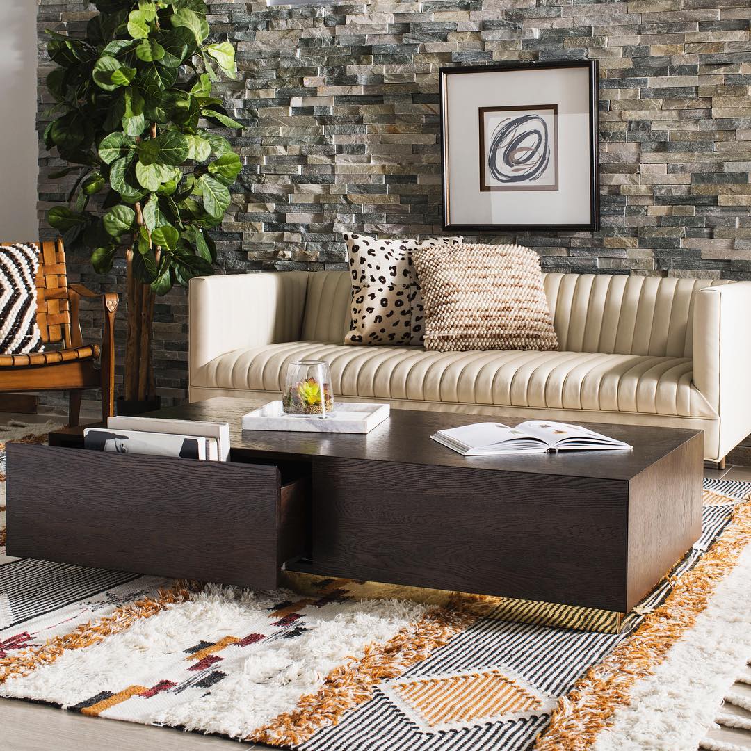 Wooden coffee table with hidden drawers on top of area rug. Photo by Instagram user @decormarkethome