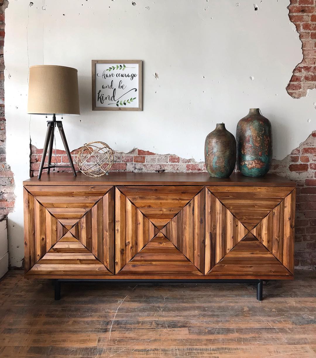 Wooden Credenza Placed in Front of a Brick Wall. Photo by Instagram user @abode_furnishings