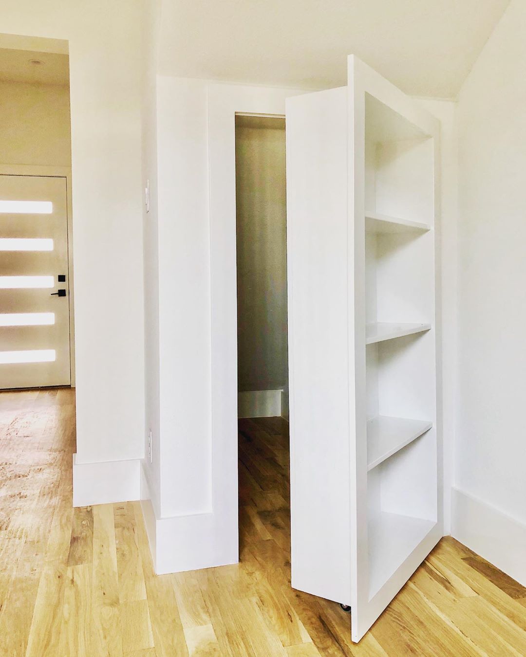 Hidden Closet Under the Stairs behind a Fake Bookcase. Photo by Instagram user @mbtrealestate
