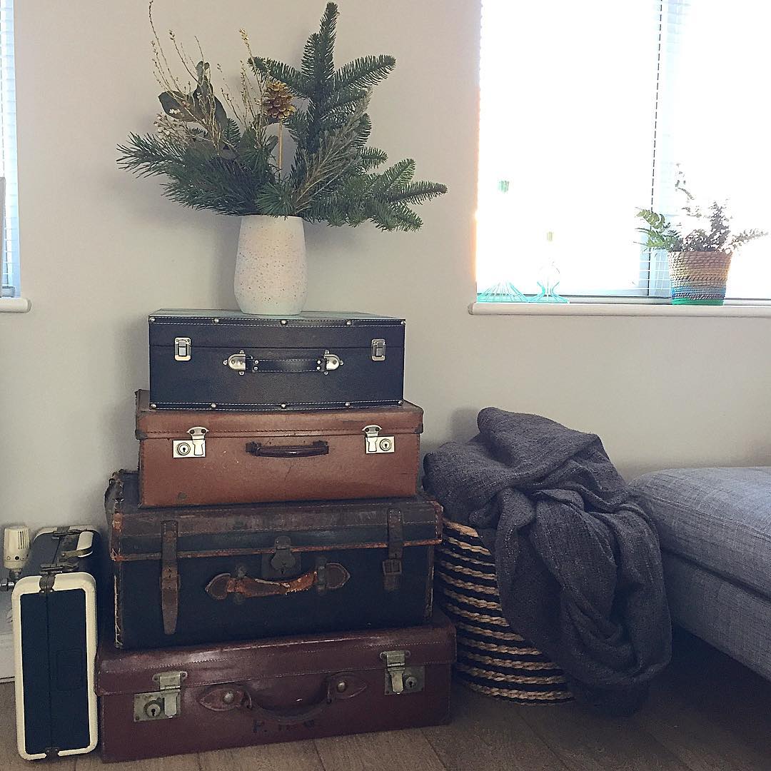 Vintage Suitcases Stacked and Used as an End Table. Photo by Instagram user @nest_number_9