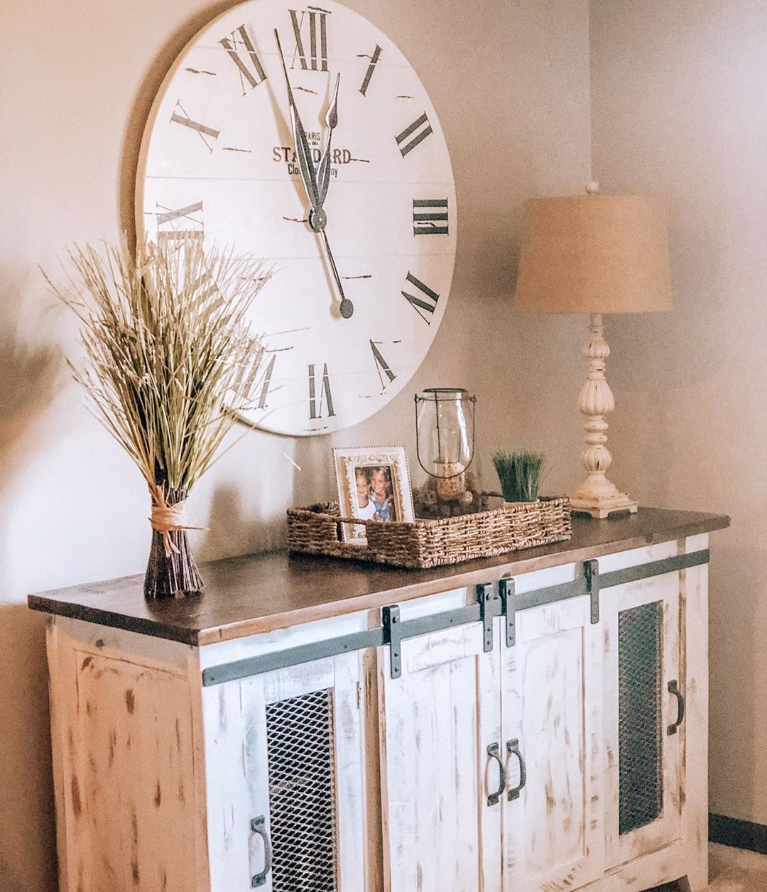Sideboard with sliding farm doors installed to hide items. Photo by Instagram user @myfarmhouseheritage
