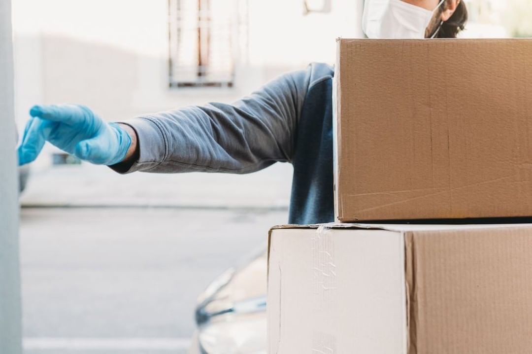 Person Wearing Rubber Gloves and Mask Moving Boxes. Photo by Instagram user @ingermancompany