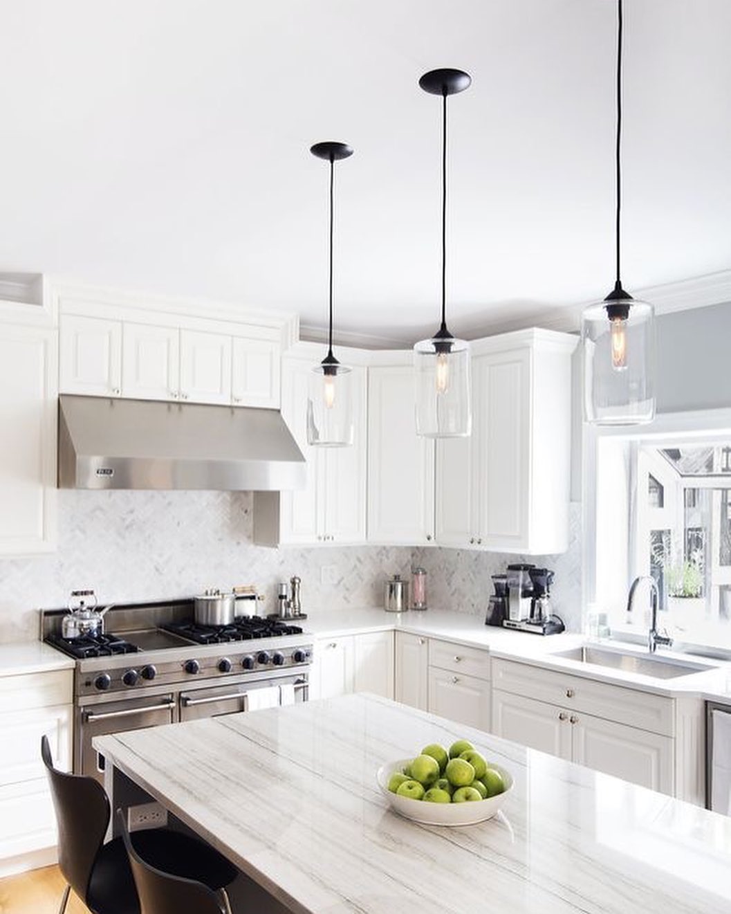 Updated Kitchen with White Cabinets and White Marble Counters. Photo by Instagram user @janeflrealestate