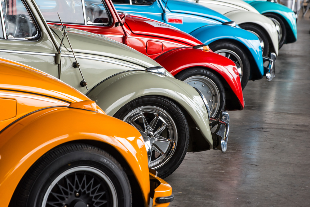 A Variety of Classic VW Beetles Parked Outside.