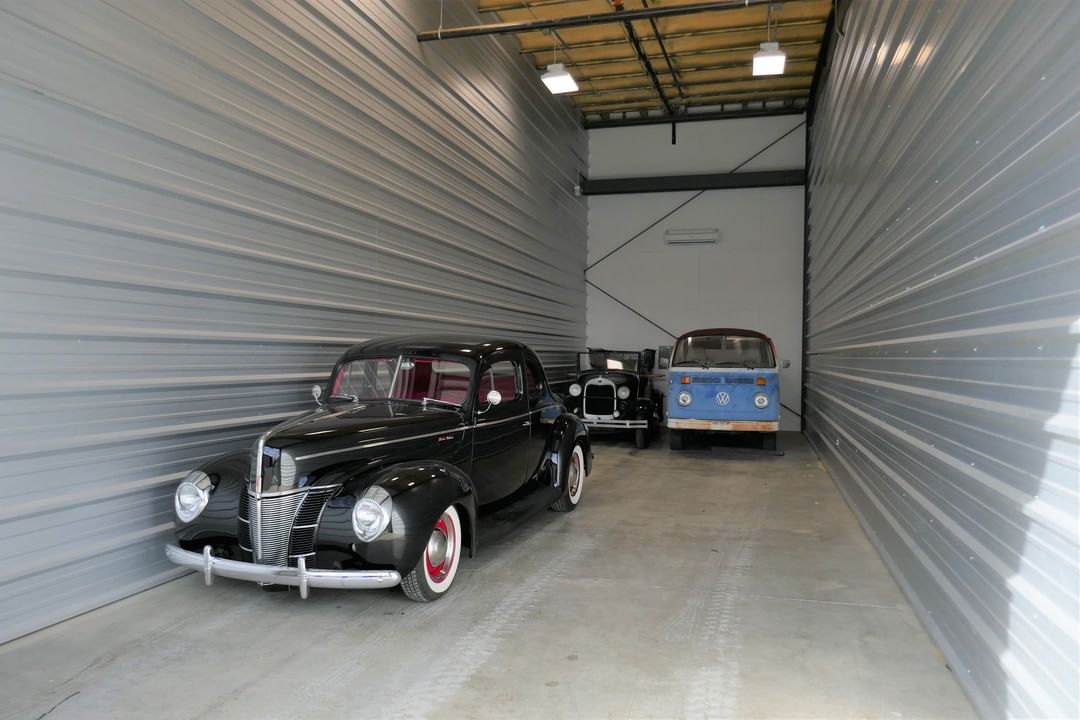Multiple Classic Cars Parked in a Drive-Up Storage Unit. Photo by Instagram user @elitestor_st.rose