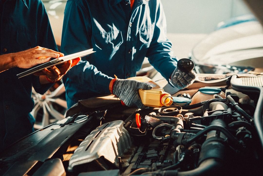 Two Technicians Changing a Car's Oil. Photo by Instagram User @actionautotireco