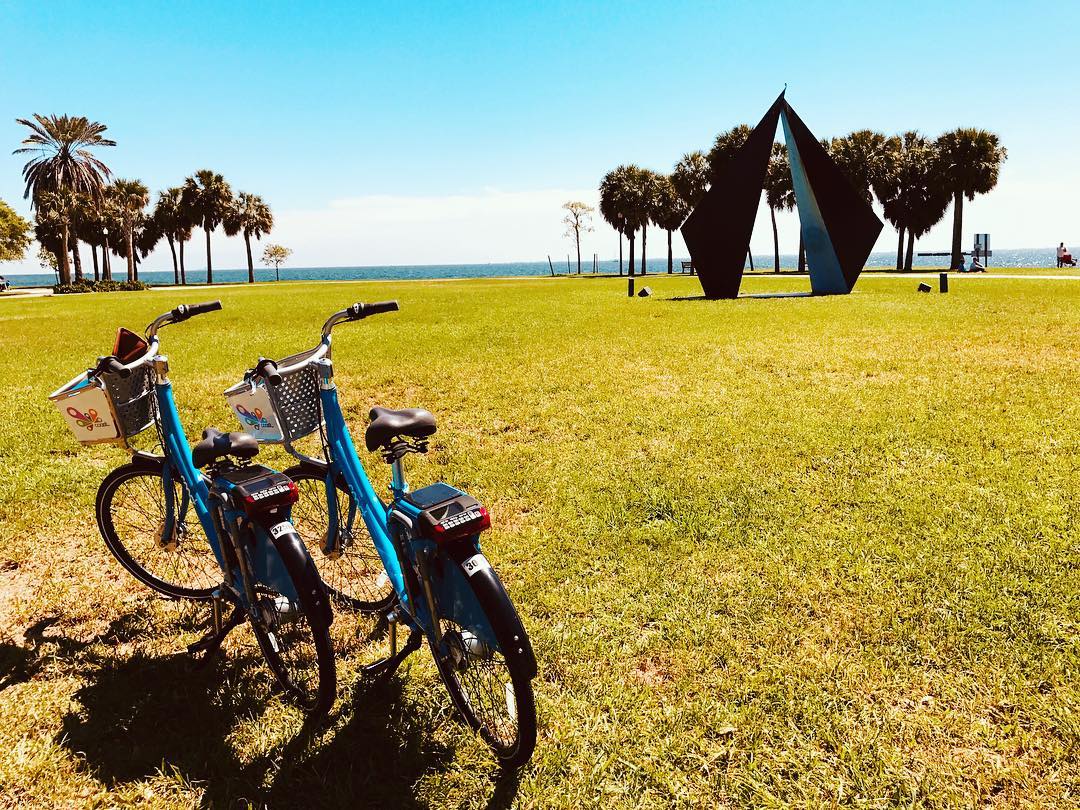Two Bikes Parked On the Grass in St. Petersburg, FL. Photo by Instagram user @stpetefl