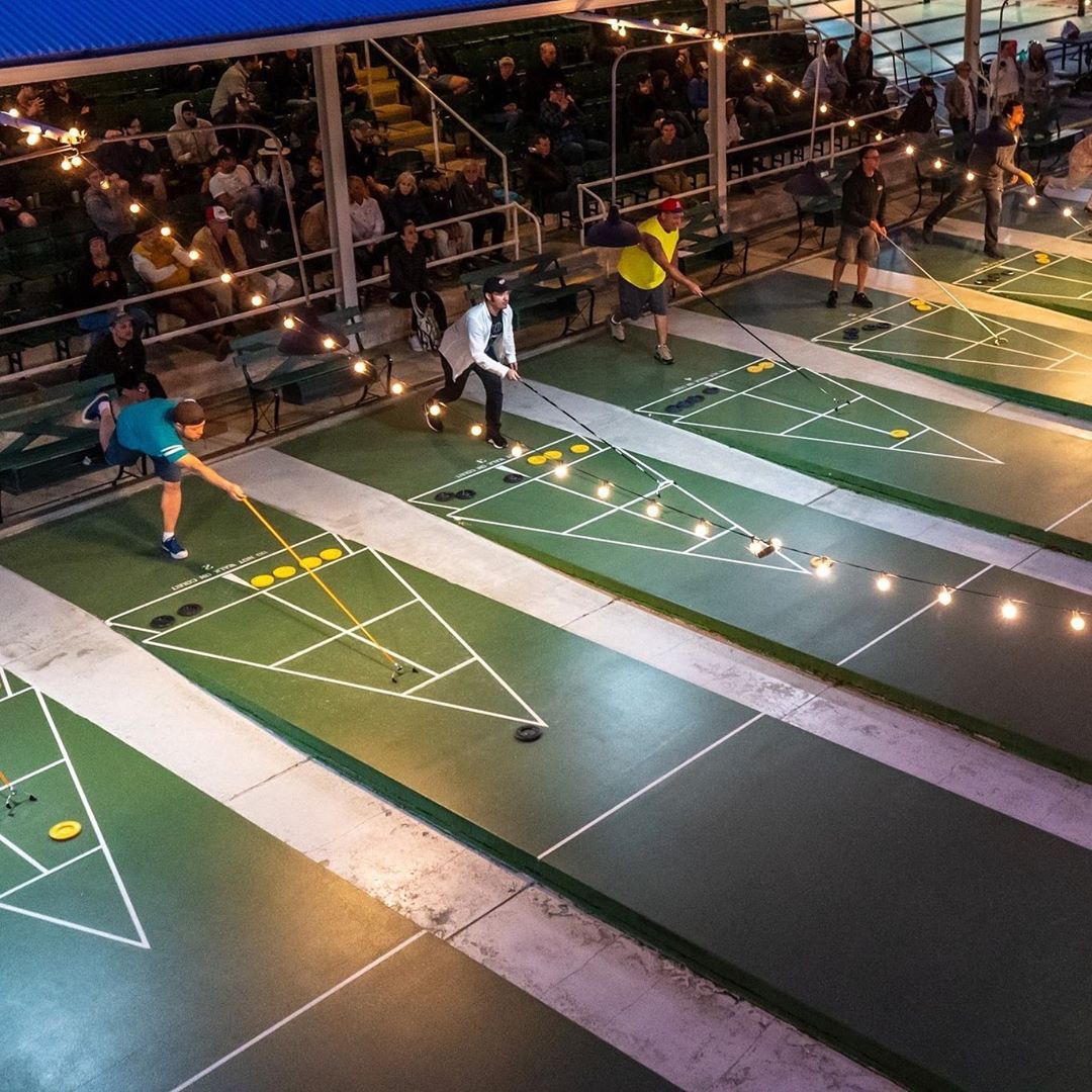 People Outside Playing Shuffleboard at a Club. Photo by Instagram user @stpeteshuffle