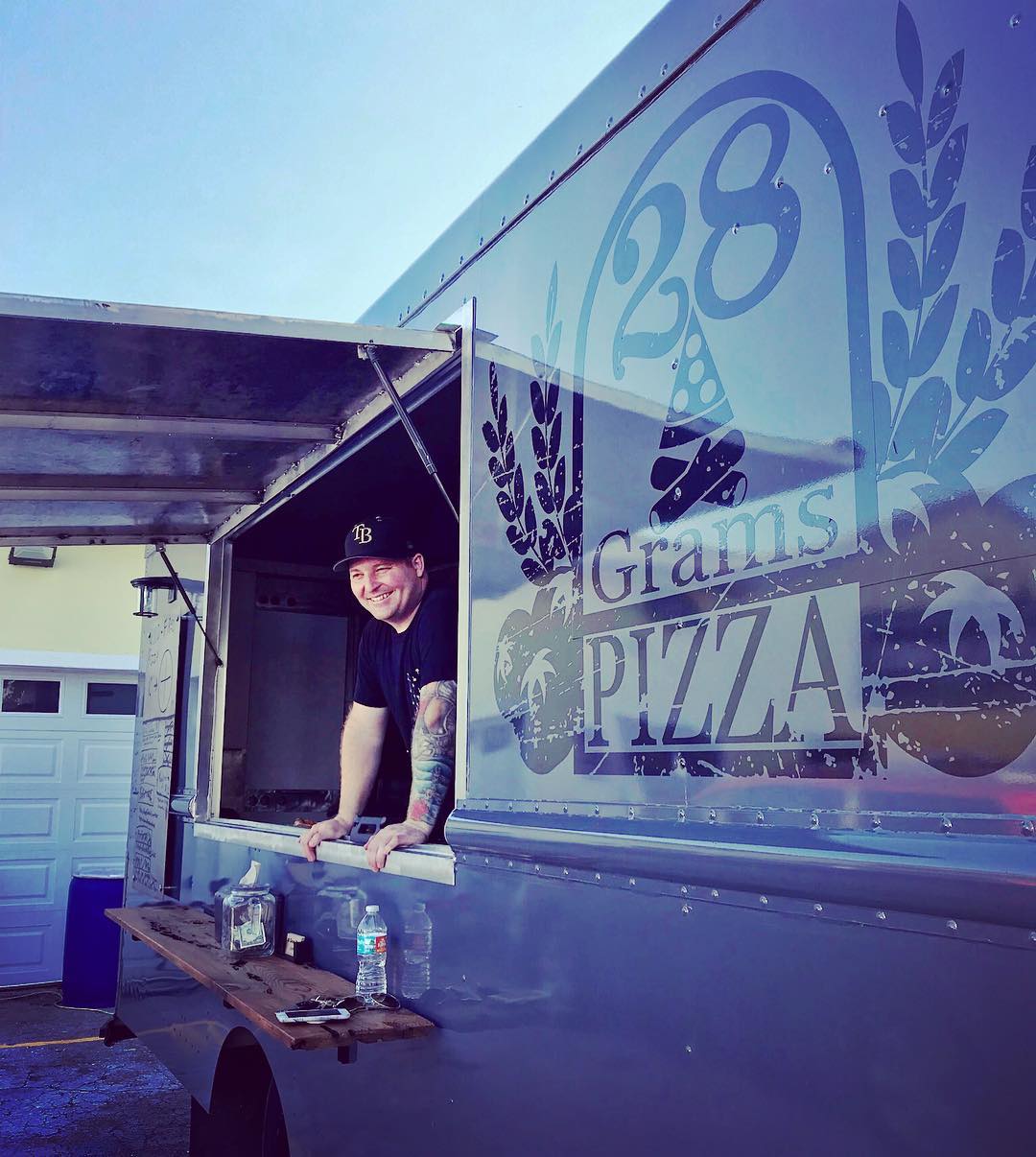 Man Standing Inside of the 28 Grams Pizza Food Truck. Photo by Instagram user @jayveehave