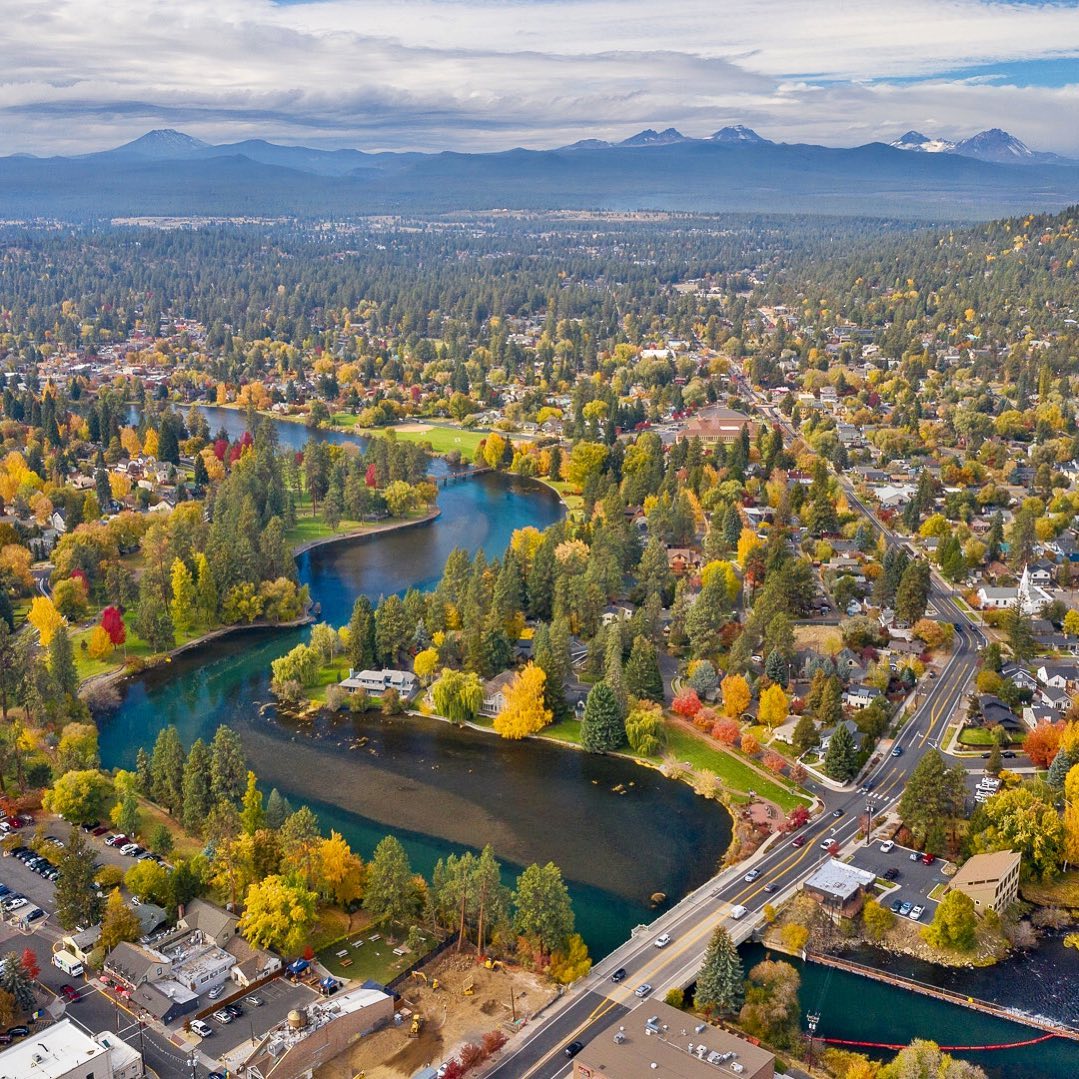 Aerial View of Bend, OR with Mountains in the Background. Photo by Instagram user @visitbend