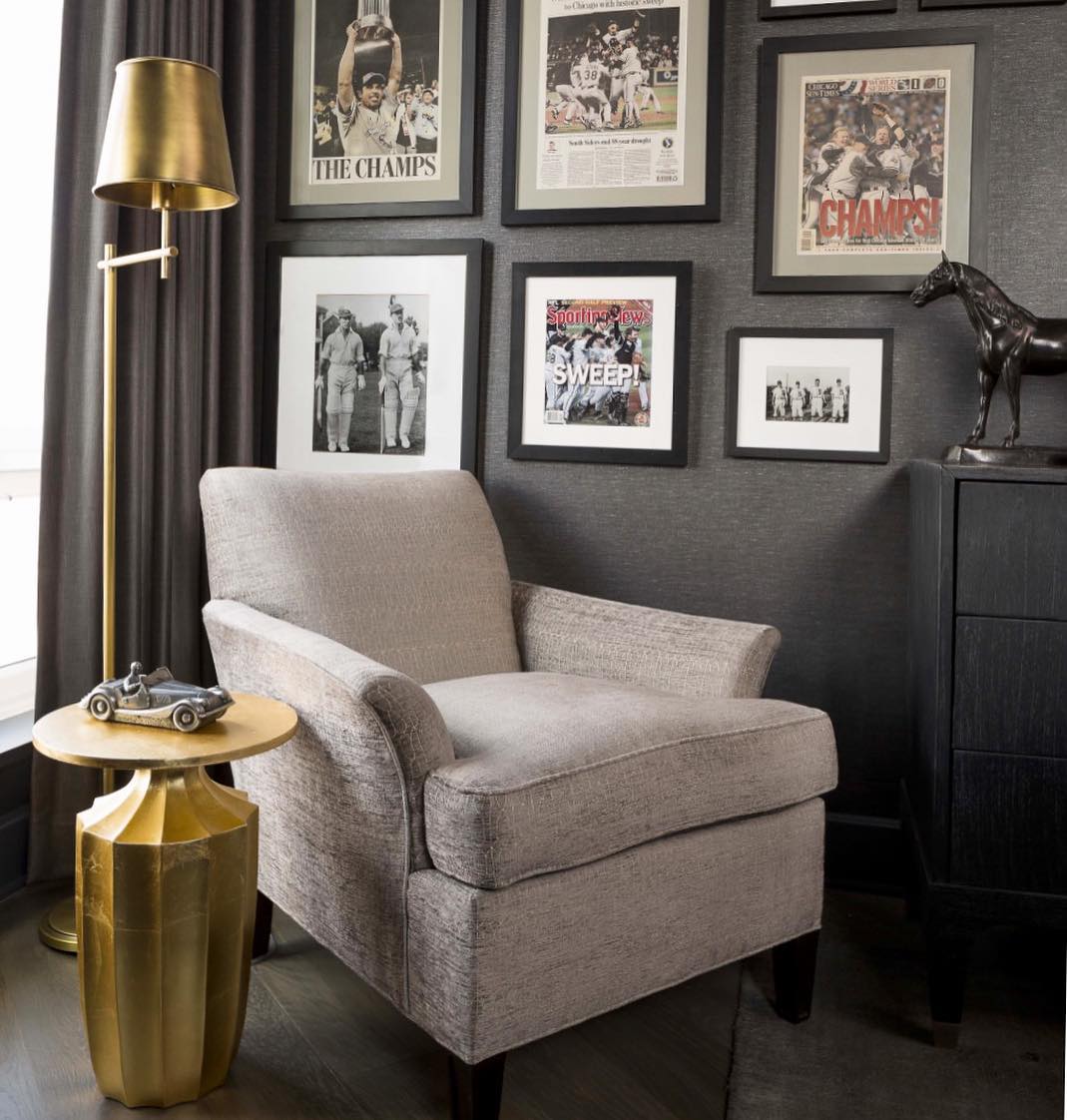 Comfy Arm Chair in Minimalistic Room with Sports Photos in Frames. Photo by Instagram user @anthonymichaelinteriors